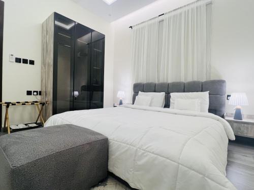 a large white bedroom with a large bed and a window at Modern Apartment 3 in Jeddah