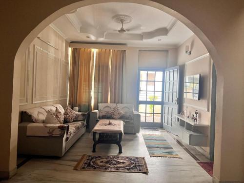 a living room with a couch and a table at Ayu Aanandam - Live I Heal I Rest in Rishīkesh