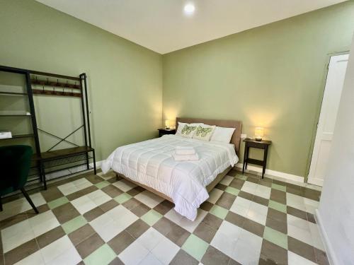 a bedroom with a bed and two side tables at Turretta Stay - Private Room with Ensuite Bathroom in Vittoriosa, Three Cities in Birgu
