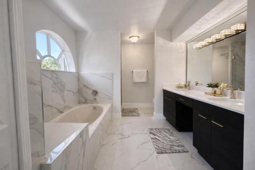a white bathroom with a tub and a sink at Villa Miami Lakes 2 in Hialeah
