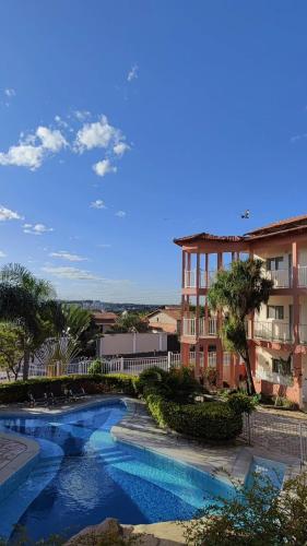 a view of a swimming pool in front of a building at Pousada 4Estações- Caldas Novas in Caldas Novas