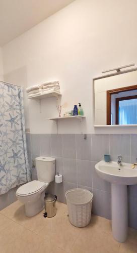 a bathroom with a toilet and a sink at La Abundancia in La Restinga