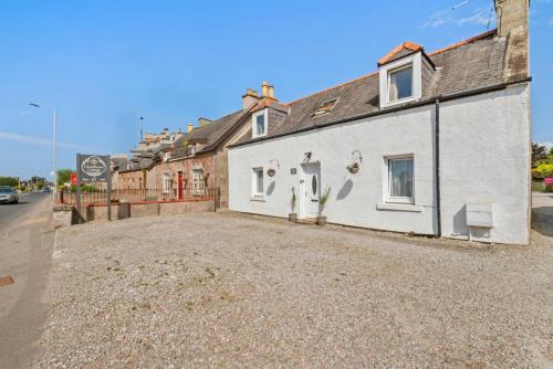 an empty parking lot in front of a house at Cloudhowe Cottage Ensuite Rooms & Studio Inverness in Inverness