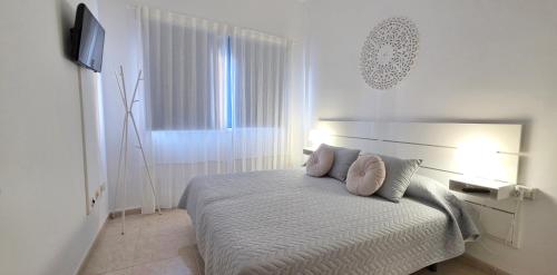 a bedroom with a bed with two pillows on it at La Abundancia in La Restinga