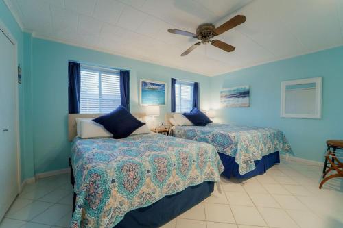 a bedroom with two beds and a ceiling fan at Bayfront Bliss Your Waterfront Getaway in Ocean City