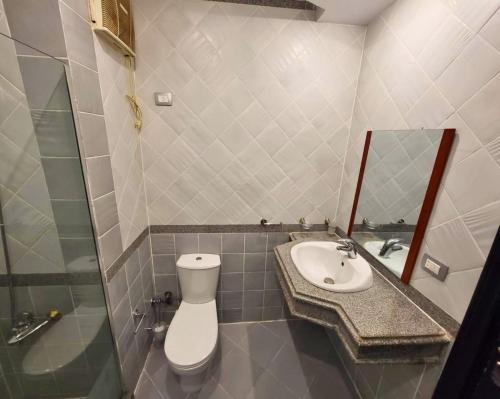 a bathroom with a toilet and a sink and a mirror at Beachfront luxury Palm Beach Piazza Private Beach in Hurghada