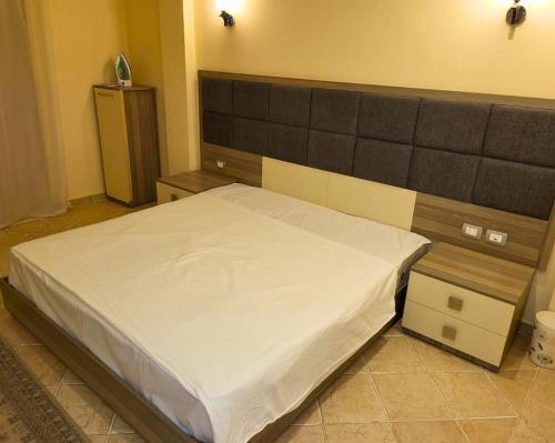 a bedroom with a large bed in a room at Beachfront luxury Palm Beach Piazza Private Beach in Hurghada