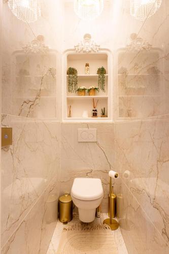 a bathroom with a white toilet in a room at Prestige Étretat in Étretat