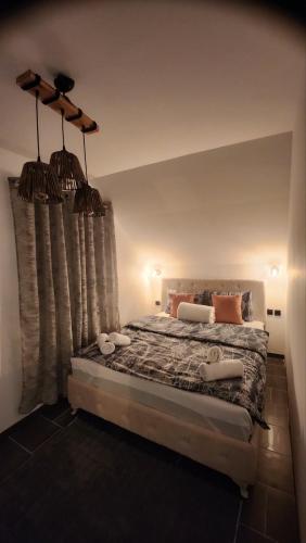 a bedroom with a bed with two pillows at Crassula Lux 4 in Surčin