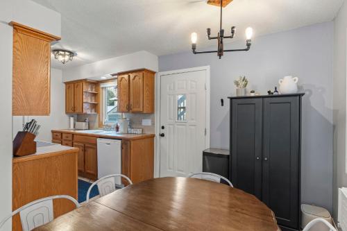 a kitchen with a wooden table and a black cabinet at The Nicollet Nook Unit 2 in Minneapolis