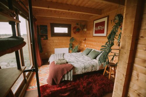 a small bedroom with a bed in a cabin at Twizel Ecostays in Twizel