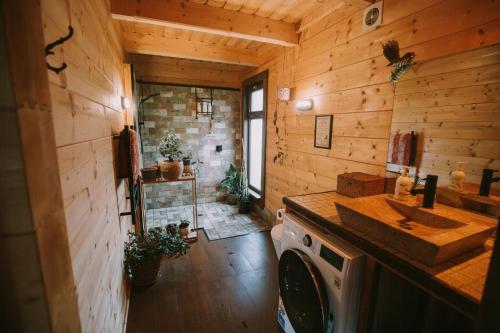 a kitchen with a sink and a washing machine at Twizel Ecostays in Twizel