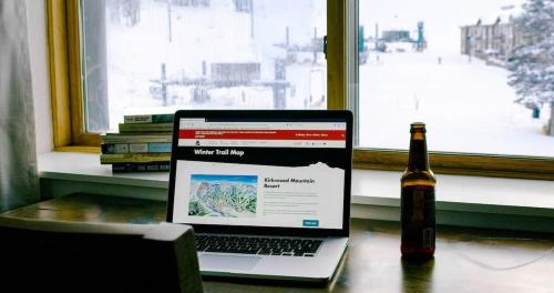 a bottle of beer and a laptop and a bottle of wine at Ski in out King bed Suite Mountain View in Kirkwood