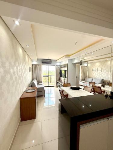a large living room with a couch and a table at Detalhes que te convida a aproveitar in Sorocaba