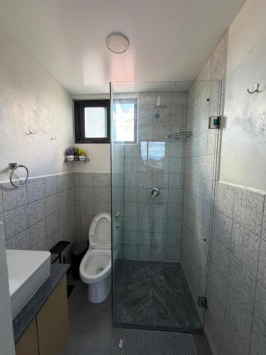 a bathroom with a toilet and a glass shower at Juárez new studio city view full equipment in Mexico City