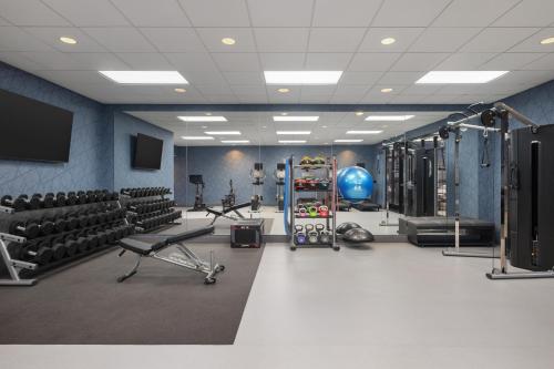 a gym with lots of equipment in a room at Homewood Suites by Hilton Fresno in Fresno