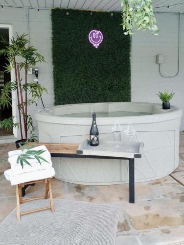 a room with a tub with a table and wine glasses at Spacious Scottsdale Getaway with Pool in Tempe