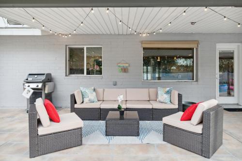 a patio with two couches and a grill at Spacious Scottsdale Getaway with Pool in Tempe