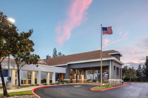 a rendering of a building with an american flag at Homewood Suites by Hilton Fresno in Fresno