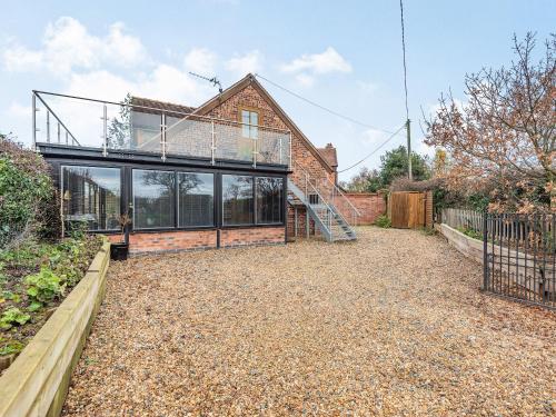 an external view of a house with a glass roof at The Barn At Whitefields in Walcot
