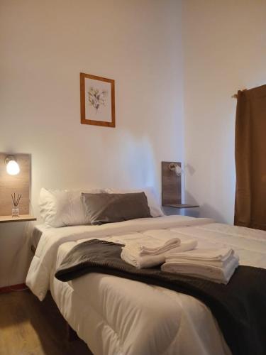 a bedroom with a bed with towels on it at Cabañas del Oeste in San Carlos de Bariloche