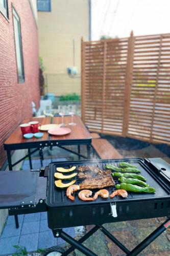 a grill with meat and vegetables on a patio at Japan Family & Kids Castle Hotel Tokyo in Kisarazu