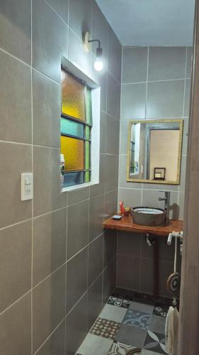 a bathroom with a sink and a mirror at Casa Del Valle Traslasierra in Las Chacras (La Paz)