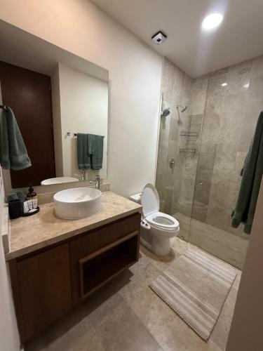 a bathroom with a sink and a toilet and a shower at Stylish 1BR Ocean View near 5th Ave in Playa del Carmen