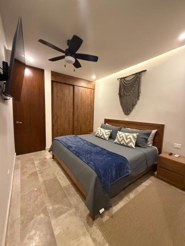 a bedroom with a bed with a ceiling fan at Stylish 1BR Ocean View near 5th Ave in Playa del Carmen