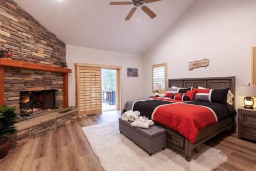 a bedroom with a large bed and a fireplace at Hillside Hideaway - game rm - master spa - Luxury in Lake Arrowhead