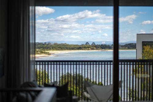 a view of a beach from a window at Piermont Retreat in Swansea