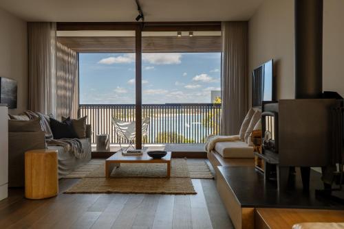 a living room with a couch and a tv at Piermont Retreat in Swansea
