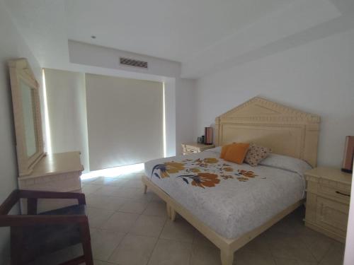 a bedroom with a bed in a room with a window at BVG Villa 1 Norte in Ixtapa