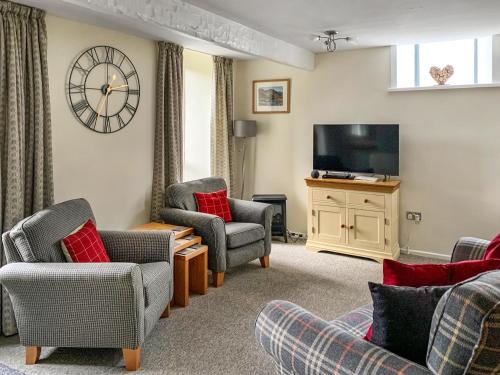 a living room with chairs and a flat screen tv at The Chapel in Staveley