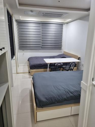 a room with two beds and a table in it at ValueStay Hotel 9A in Seoul