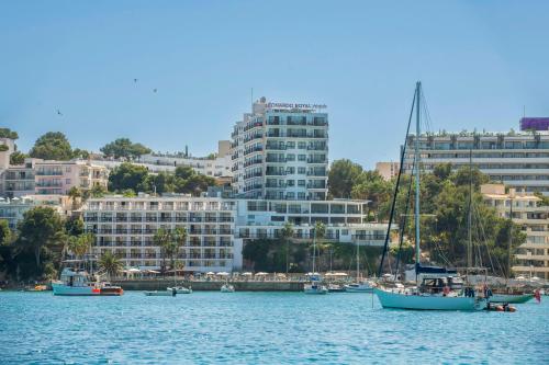 a group of boats in a body of water with buildings at Leonardo Royal Hotel Mallorca in Palmanova