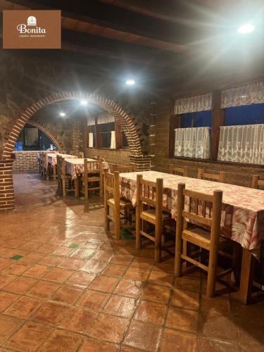 a row of tables and chairs in a restaurant at Quinta Bonita in Zacatlán