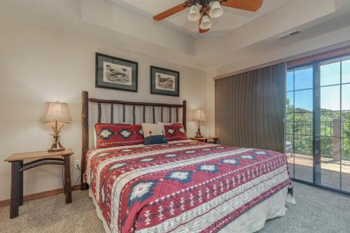 a bedroom with a bed and a large window at 1BR Village At Indian Point 2102 near SDC-Free Tickets Daily up to $500 in Branson