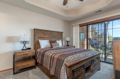 a bedroom with a bed and a balcony at 2BR Village At Indian Point 1202 near SDC-Free Tickets Daily up to $500 in Branson