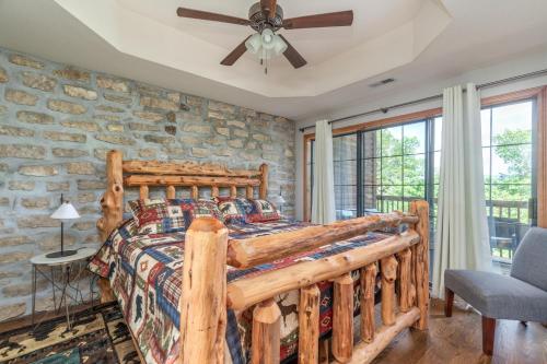 a bedroom with a wooden bed and a stone wall at 1BR Village At Indian Point 1104 near SDC-Free Tickets Daily up to $500 in Branson