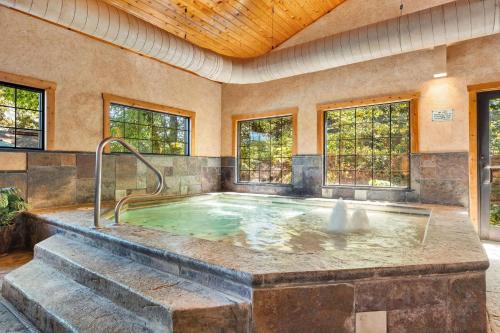 a hot tub in a room with windows at 1BR Village At Indian Point 2004 near SDC-Free Tickets Daily up to $500 in Branson