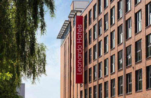 a red sign on the side of a building at Leonardo Hotel Hamburg Altona in Hamburg