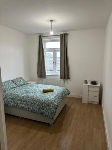 a bedroom with a bed and a window at Prentis Road in London