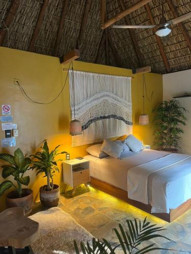 a bedroom with a bed in a room at Sicaru Mazunte in Mazunte