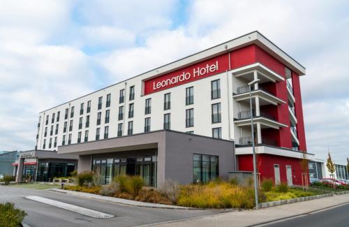 a red and white building with a hotel at Leonardo Hotel Bad Kreuznach in Bad Kreuznach