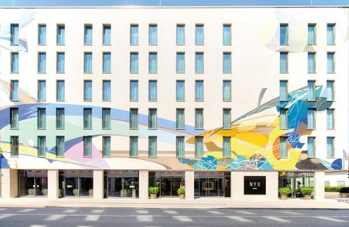 a building with a mural on the side of it at NYX Hotel Munich by Leonardo Hotels in Munich
