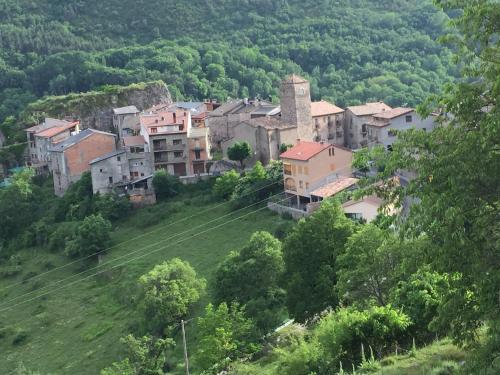a group of houses on a hill in a village at La Fusteria del Casat in Sarroca de Bellera