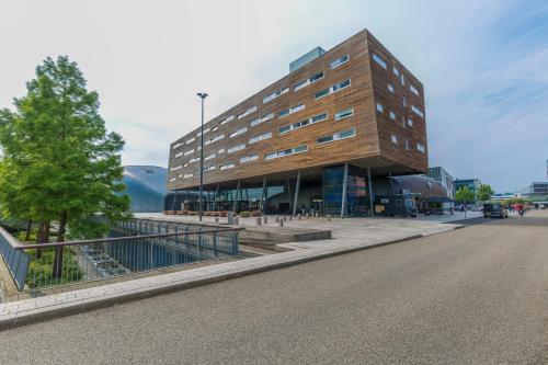 a building on the side of a street at Leonardo Hotel Almere City Center in Almere