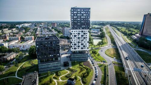 an aerial view of a tall building in a city at Leonardo Hotel Groningen Stadspark in Groningen