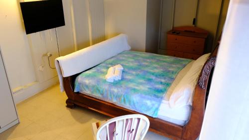 a small bedroom with a bed and a chair at Comoda casa en segunda planta in Coamo